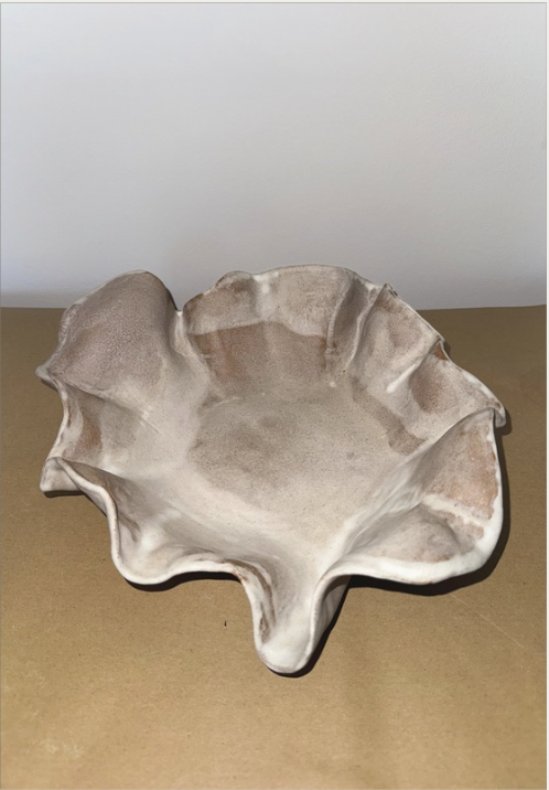 A ceramic bowl with a soft, ruffled organic edge